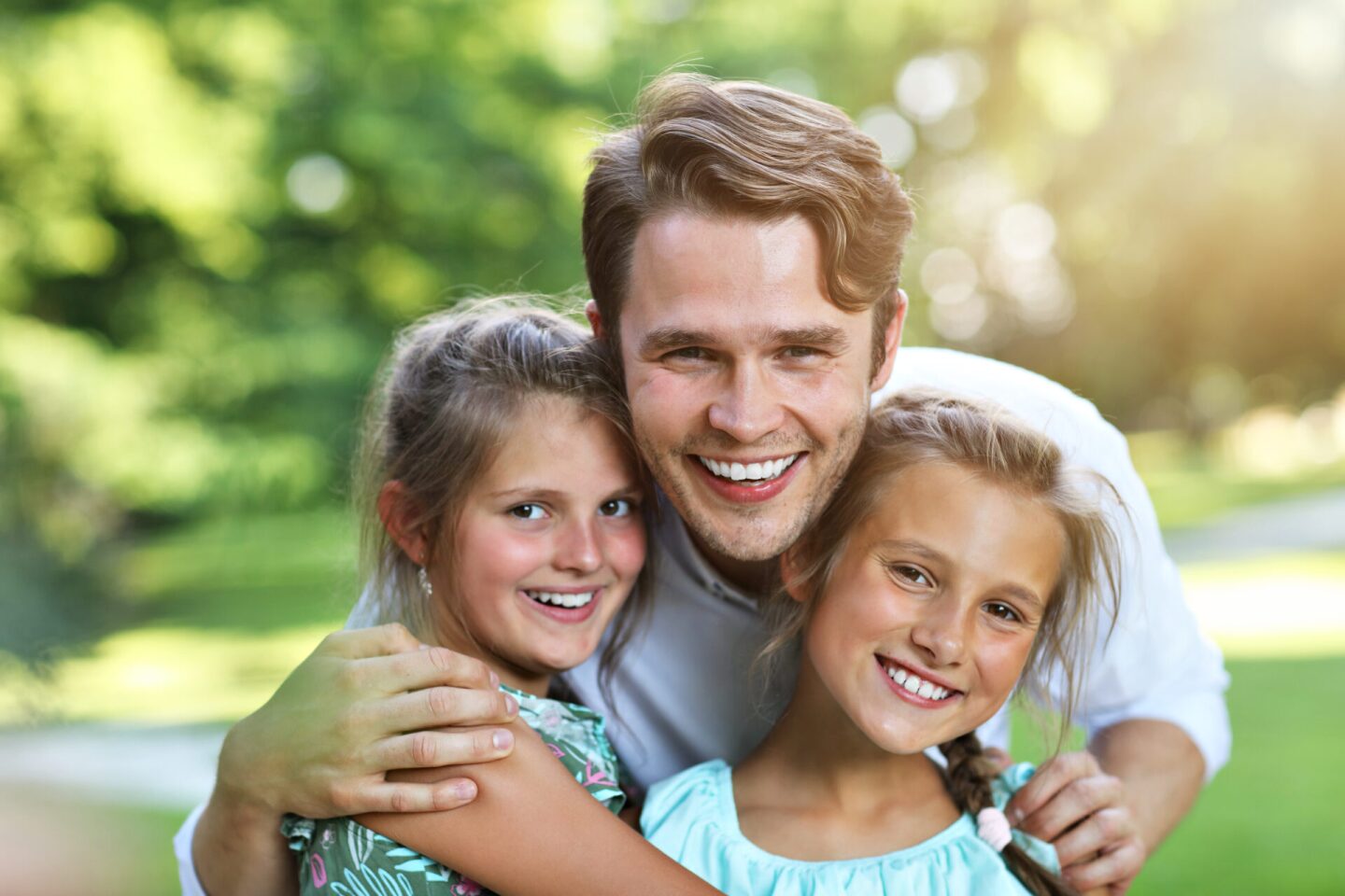Young dad with children having fun in nature