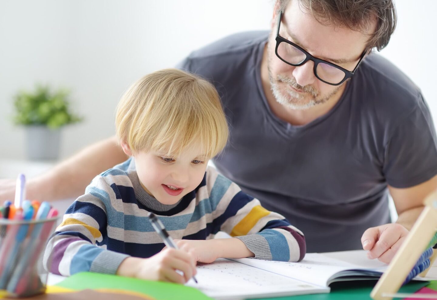 father-helping-child-do-his-homework-at-home-tuto-2023-07-12-02-34-53-utc (1)
