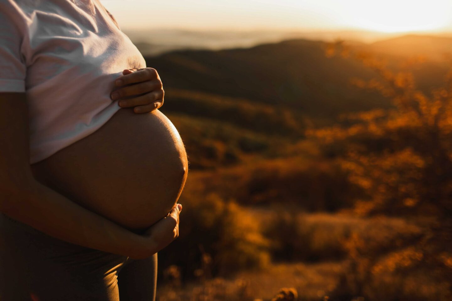 woman-hands-hold-belly-in-pregnancy-outdoors-clos-2021-08-31-13-48-40-utc (1)
