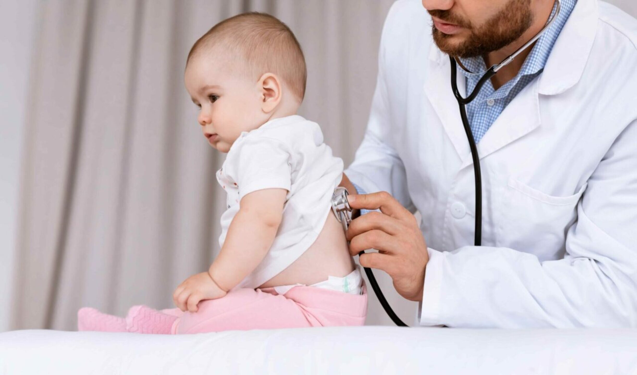 doctor-examining-baby-listening-lungs-on-medical-c-2022-12-16-08-07-13-utc-1-1280x754