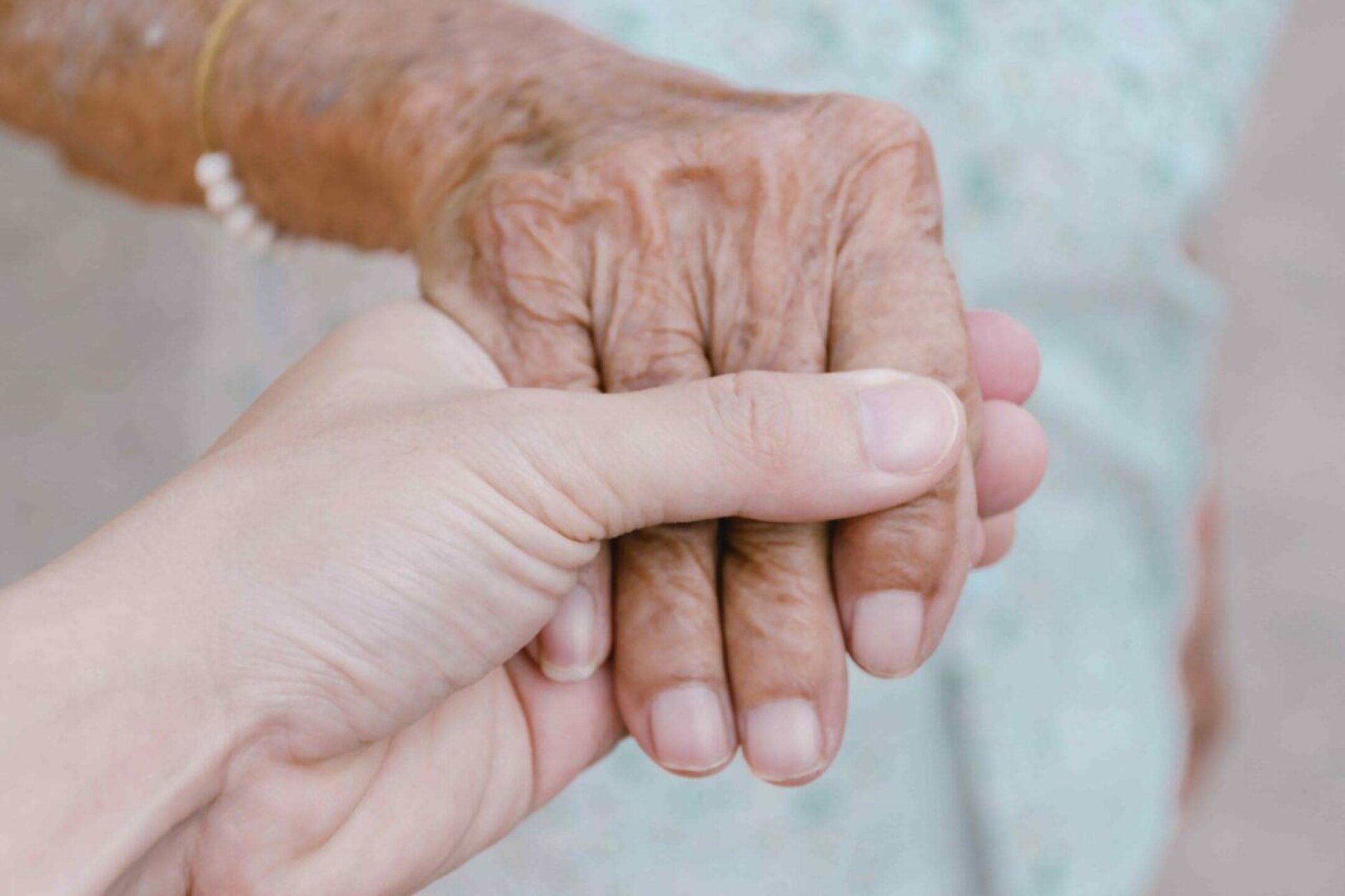 young-male-man-holding-his-grandmother-hand-with-c-2022-11-17-09-23-07-utc-1-1280x853