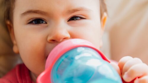 funny baby drinking bottled water
