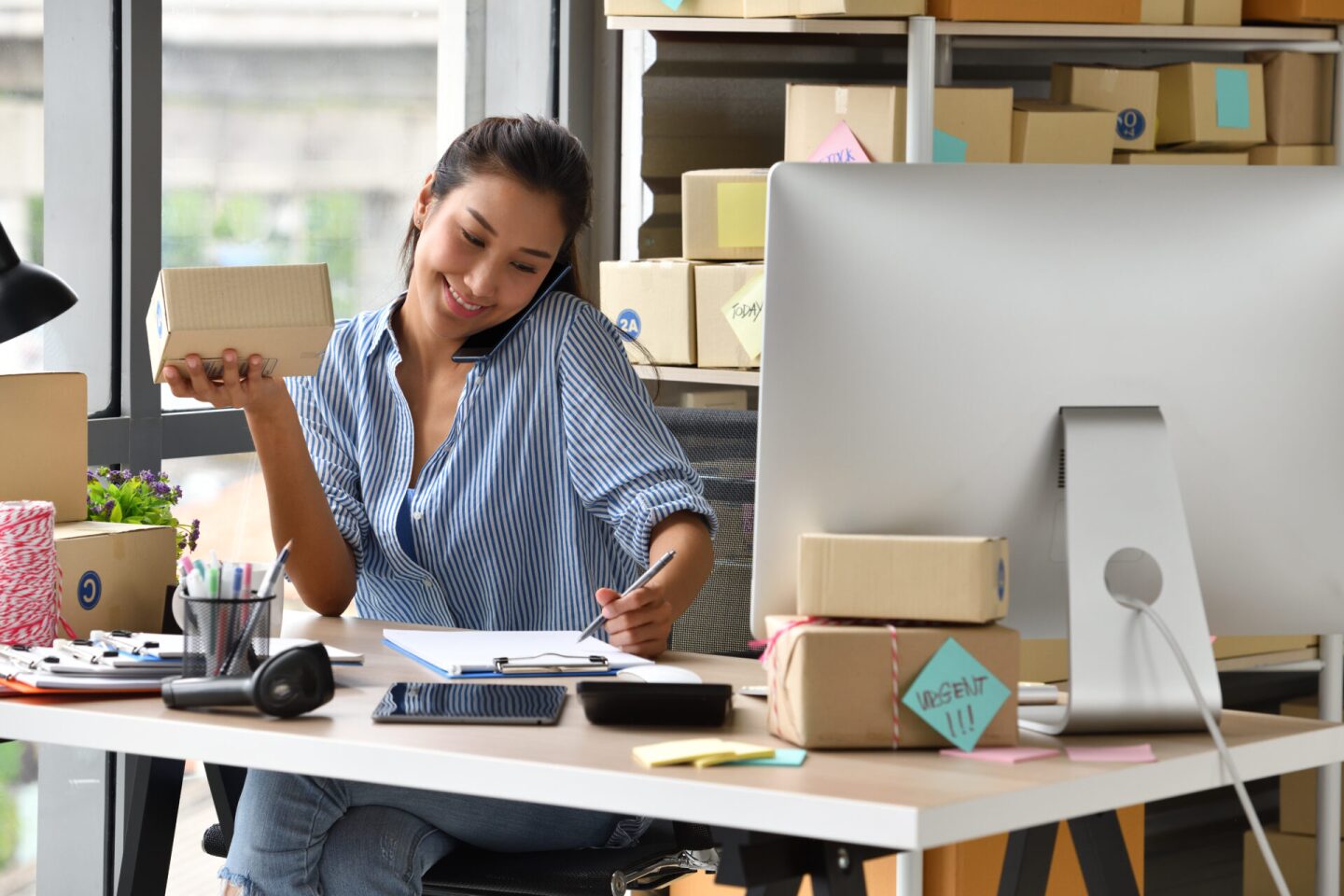 Young Asian woman entrepreneur/ Business owner working with computer at home