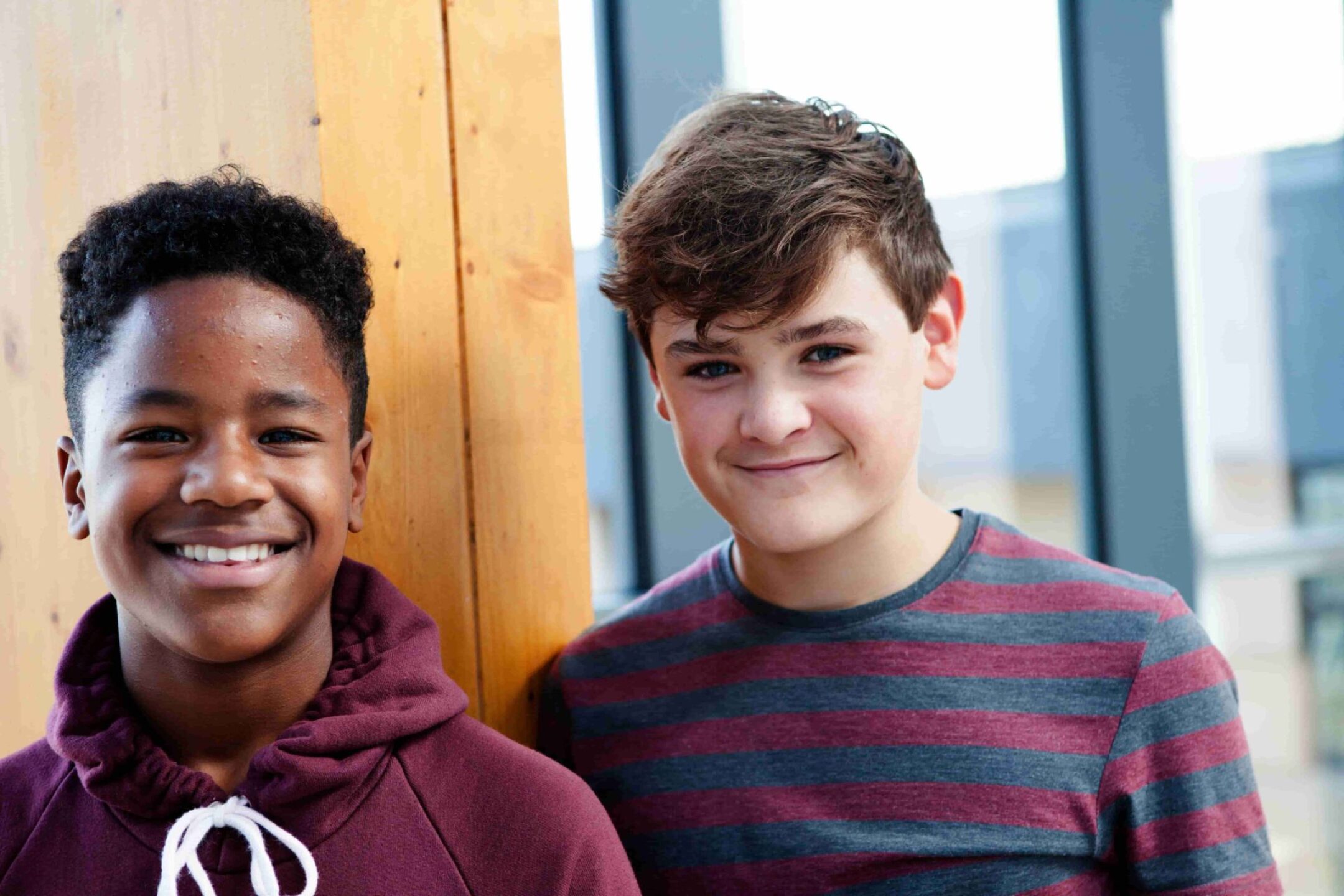portrait-of-two-teenage-schoolboys-in-corridor-2023-11-27-05-25-56-utc-1