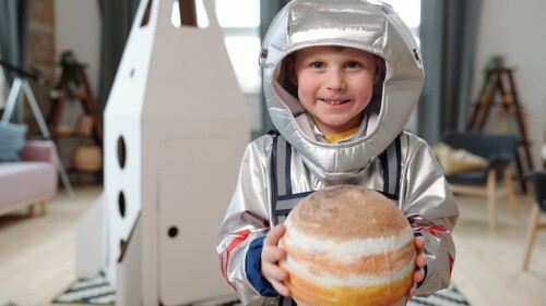 little-boy-in-space-suit-holding-planet-of-solar-s-2023-11-27-04-53-57-utc (1)
