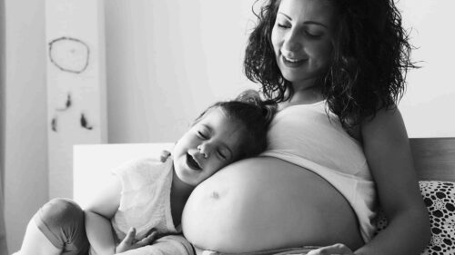 happy-kid-girl-hugging-pregnant-mother-s-belly-2021-08-26-15-59-32-utc (1)