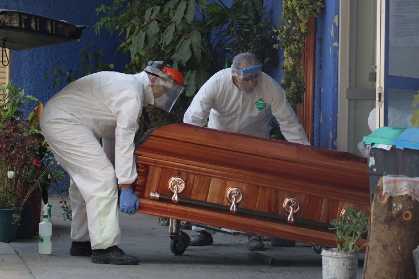 Cremadores sostienen el féretro de una muerte natural en el Velatorio Xilotepec