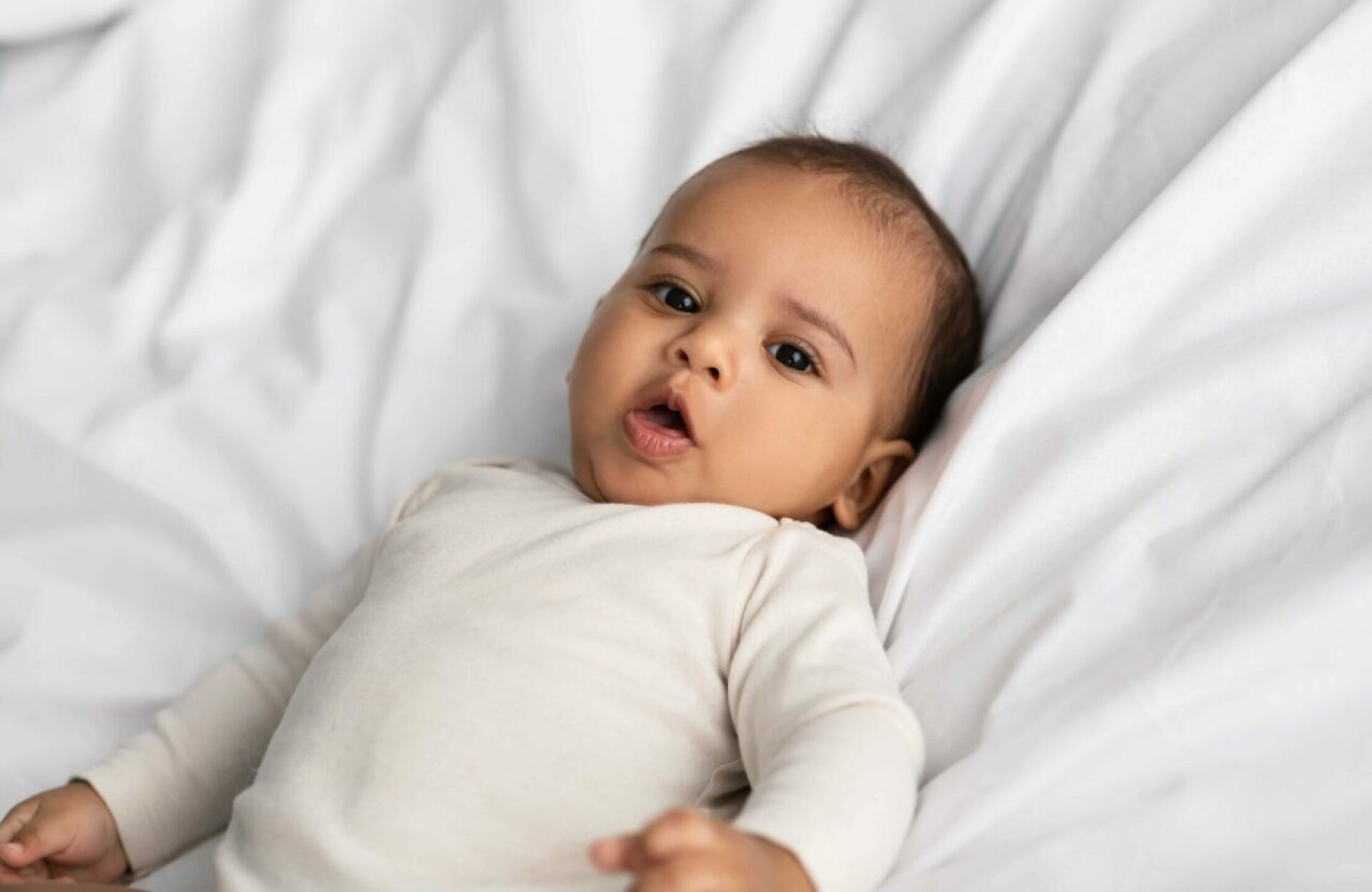 cute-little-african-american-infant-lying-in-bed-2022-12-16-07-05-55-utc-1-1280x832