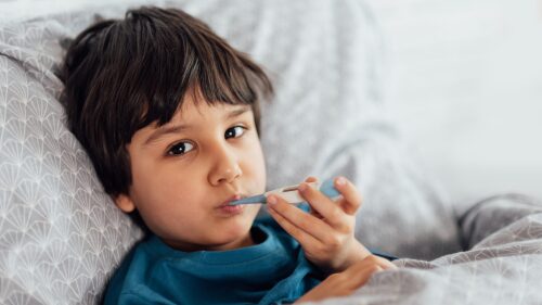 Child flu sick, boy with medical thermometer in mouth, health illness. Kid with cold rhinitis,
