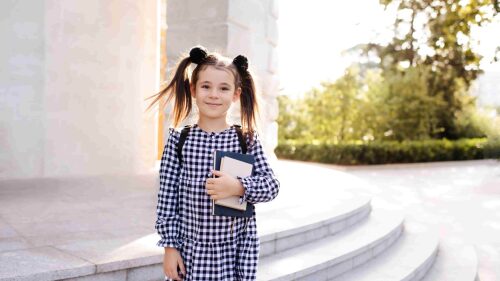 smiling-little-kid-girl-hold-books-for-study-retur-2022-11-17-15-44-36-utc (1)