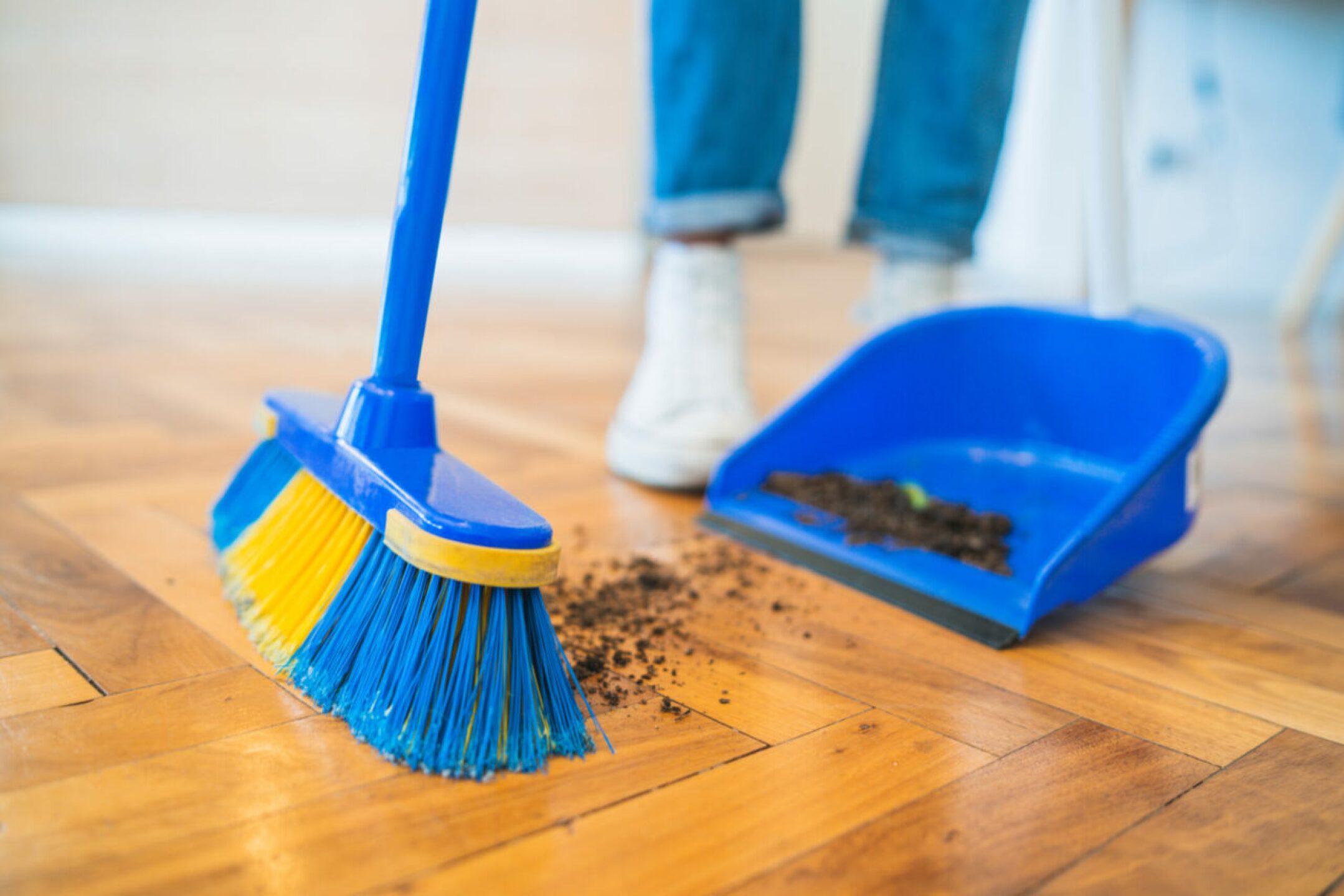 latin-man-sweeping-wooden-floor-with-broom-at-home-2021-08-28-10-59-00-utc-1280x854