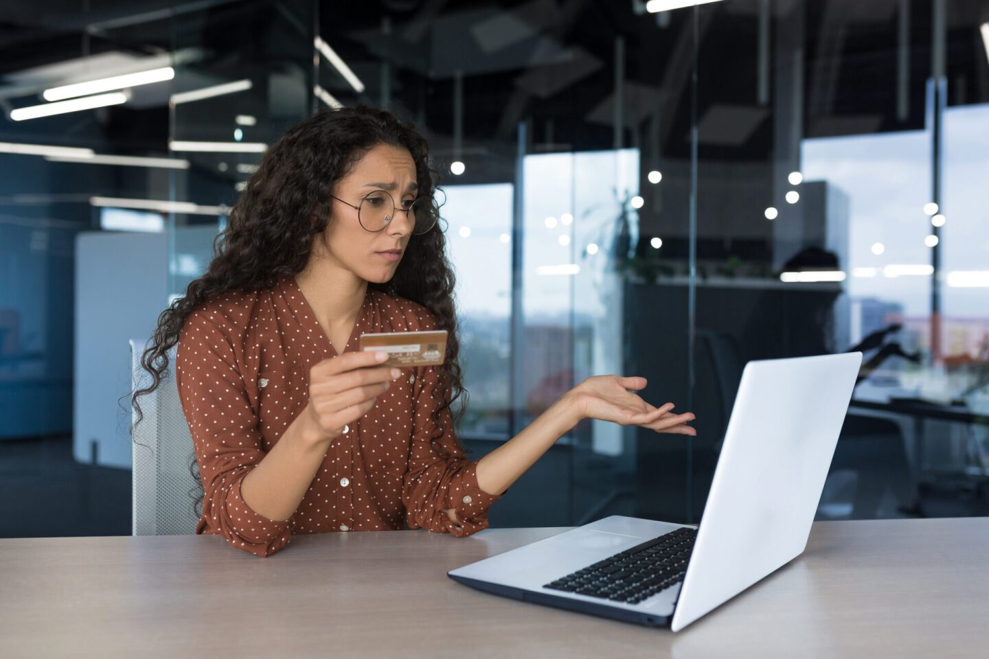 Upset business woman in modern office trying to make a purchase in an online store