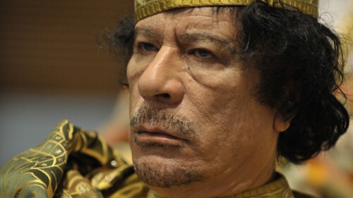 Muammar Gaddafi, Leader of the Revolution of the Great Socialist People’s Libyan Arab Jamahiriya, sits reading in the Plenary Hall of the United Nations (UN) building in Addis Ababa, Ethiopia, during the 12th African Union (AU) Summit