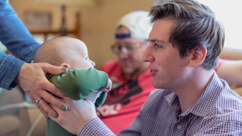 young-man-hiking-baby-at-family-party-2022-11-11-07-23-31-utc (1)