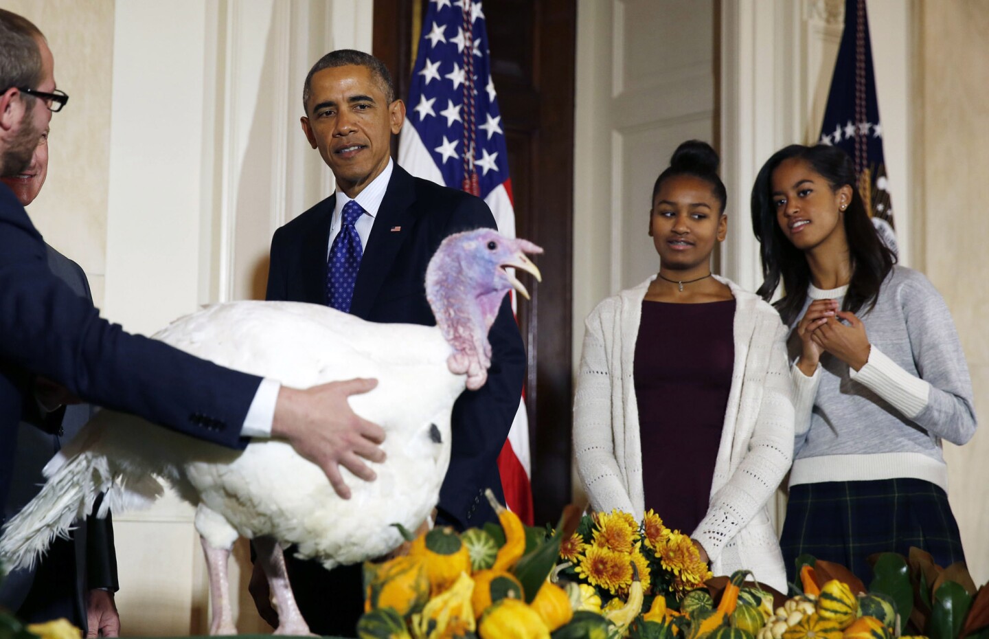 U.S. President Barack Obama is joined by his daughters, Sasha and Malia as they all participate in the annual turkey pardoning ceremony in the White House in Washington