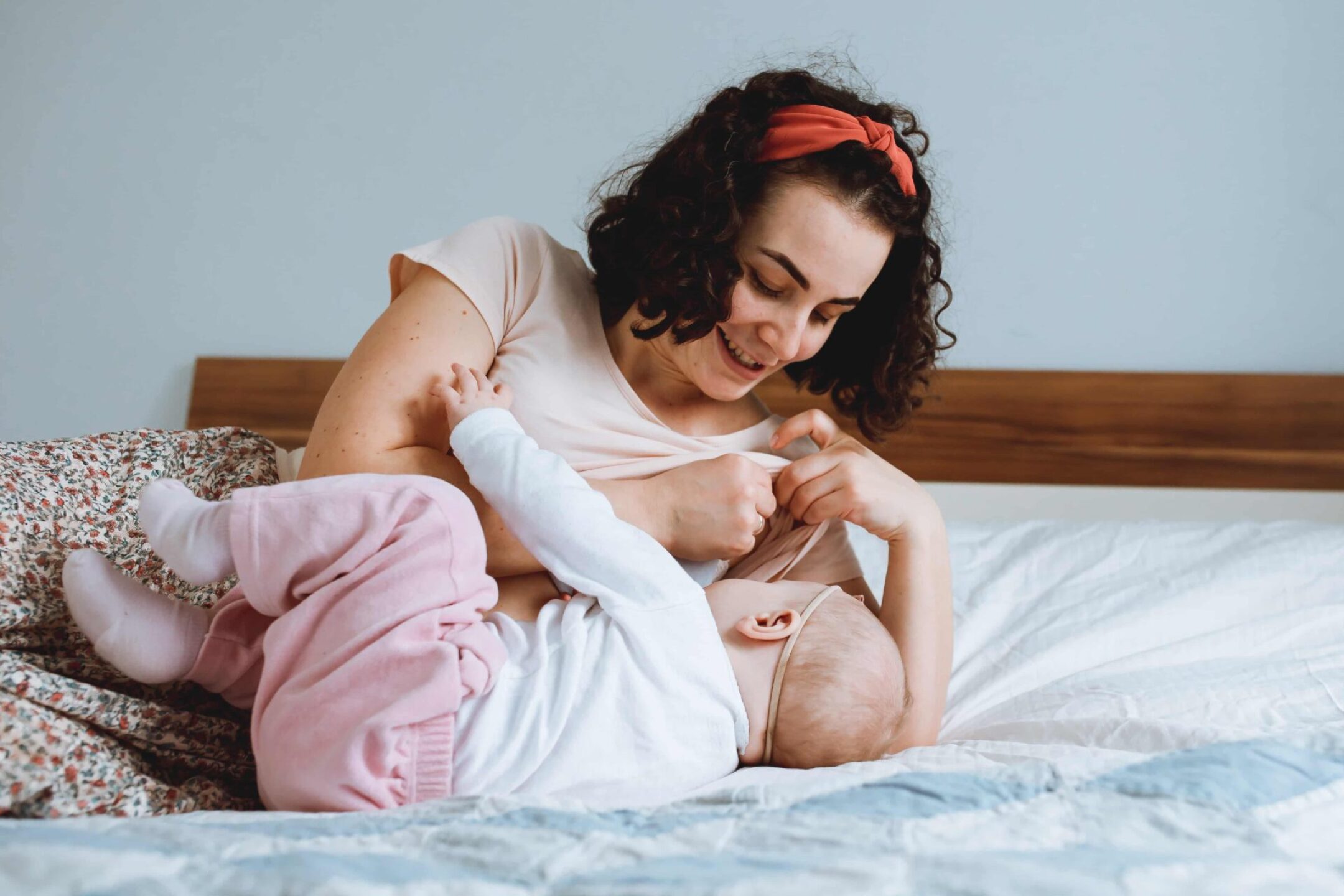 mother-breastfeeding-baby-on-the-bed-motherhood-2023-11-27-05-33-47-utc-1