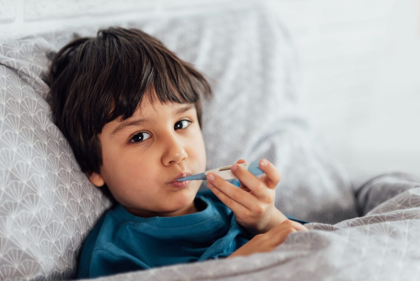 Child flu sick, boy with medical thermometer in mouth, health illness. Kid with cold rhinitis,