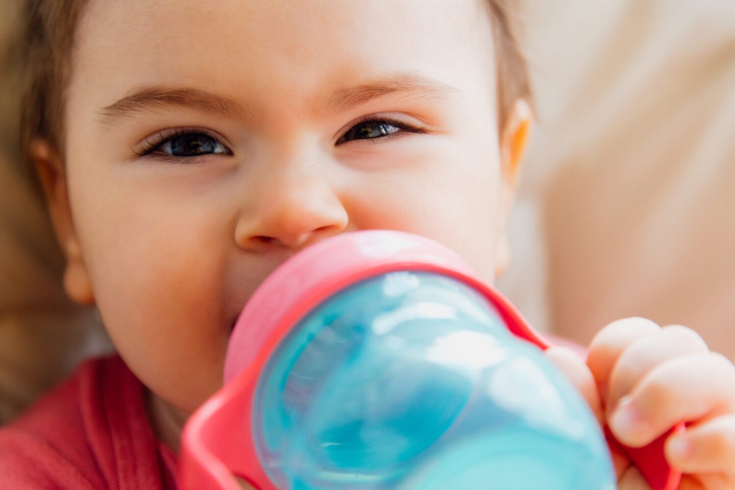 funny baby drinking bottled water