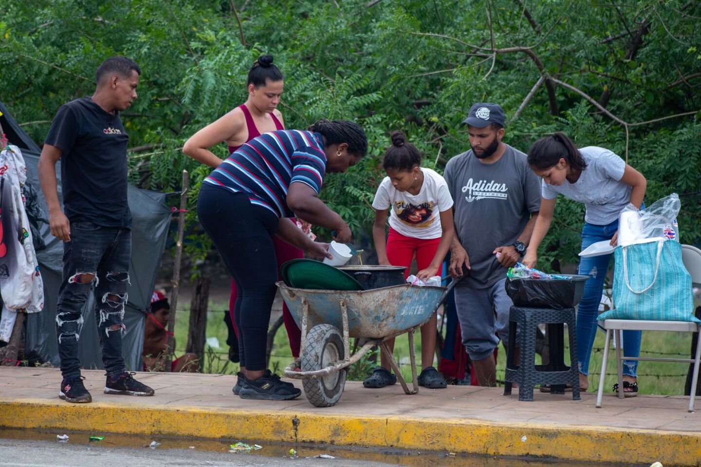 Las personas en estado de migración preparan alimentos y bebidas para comercializar entre ellos