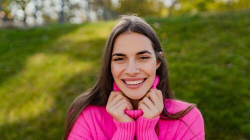 young-smiling-woman-in-pink-sweater-walking-in-gre-2021-12-09-08-34-15-utc (1)