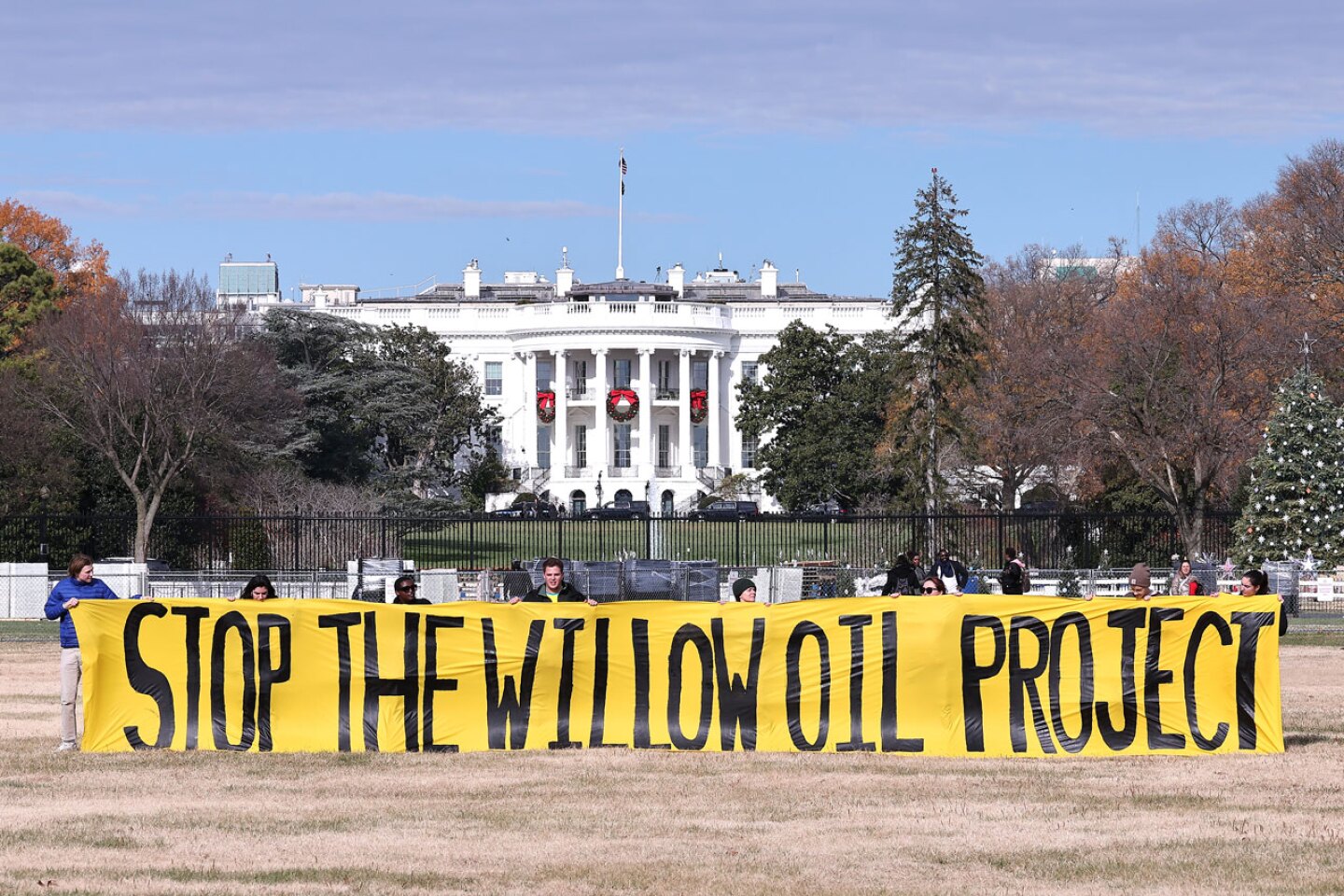 Students And Community Members Demand President Biden Stop The Willow Project By Unfurling A Banner At The Ellipse Outside The White House