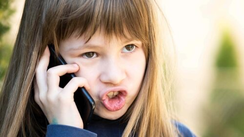 portrait-of-angry-child-girl-with-long-hair-talkin-2022-05-30-22-34-32-utc (1)