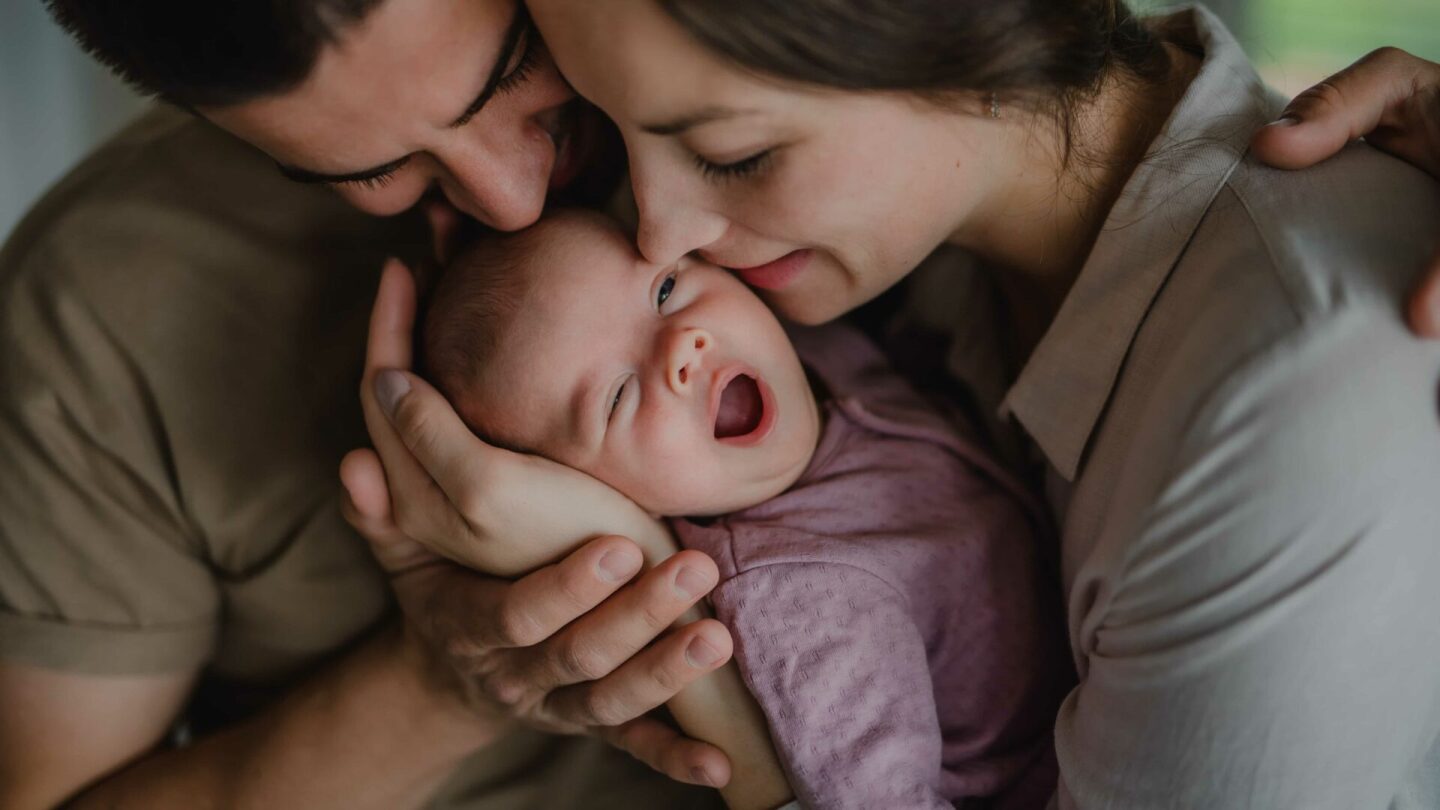 close-up-of-young-parents-holding-and-kissing-thei-2022-01-18-23-51-00-utc (1)