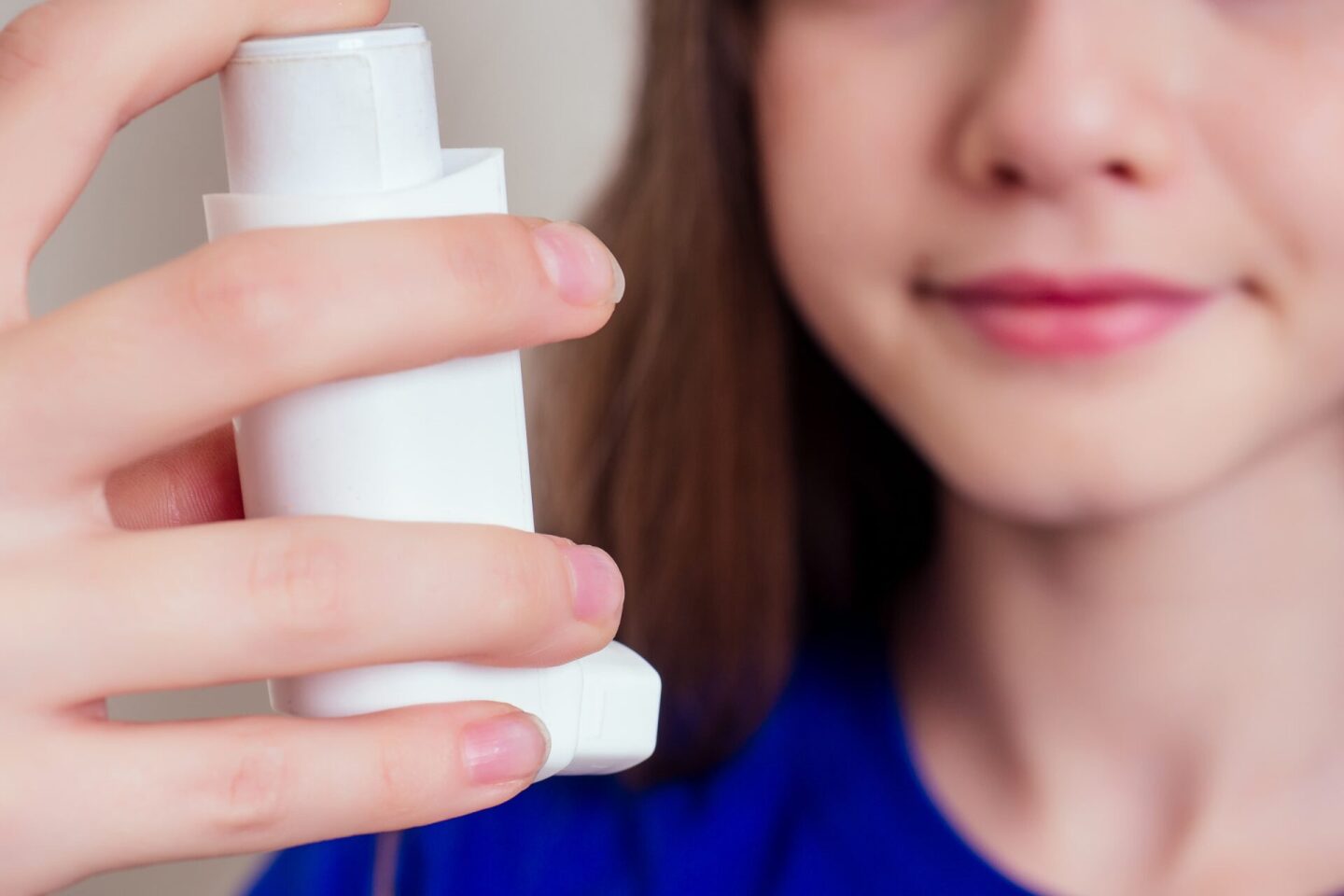 young-teen-girl-woman-using-asthma-inhaler-at-home-2022-06-01-18-02-01-utc (1)
