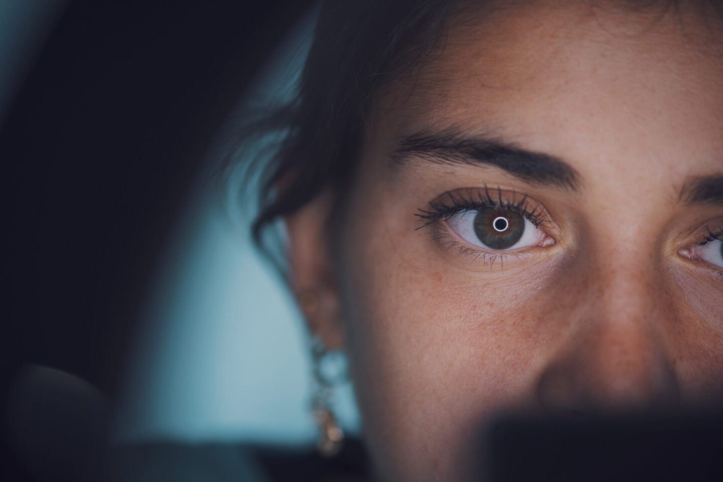 Ring light reflecting in woman's eye