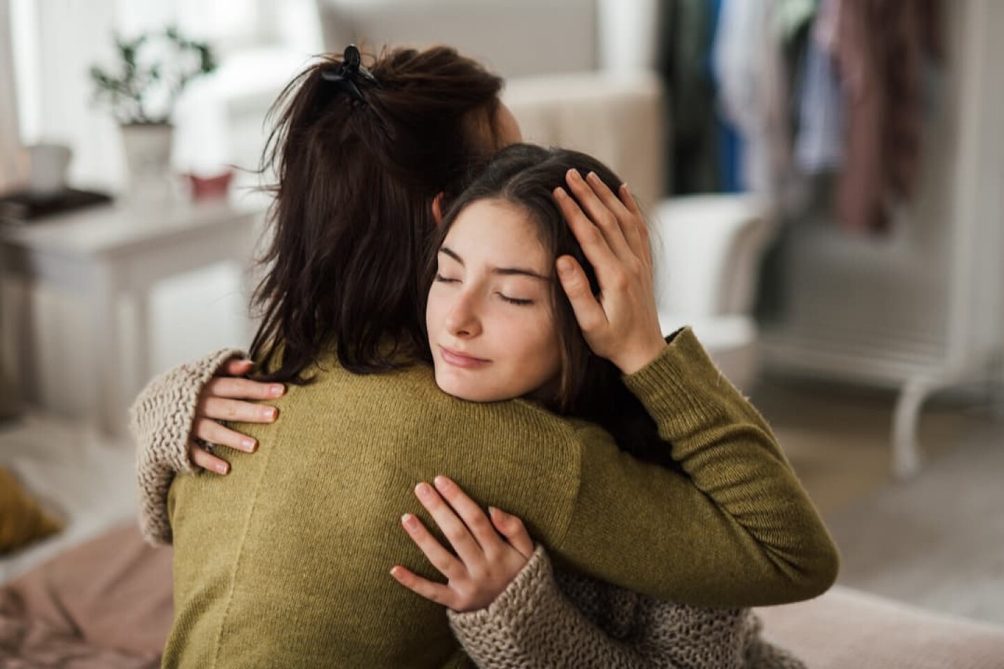 teenage-girl-hugging-her-mother-at-home-2023-11-27-05-08-01-utc